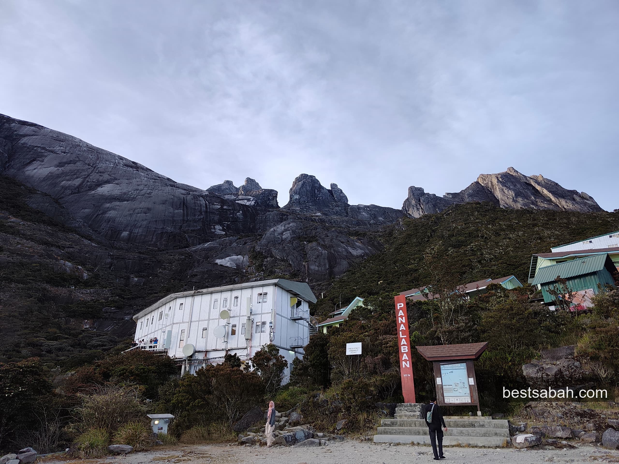 Laban Rata rest house at dusk with granite peaks rising above