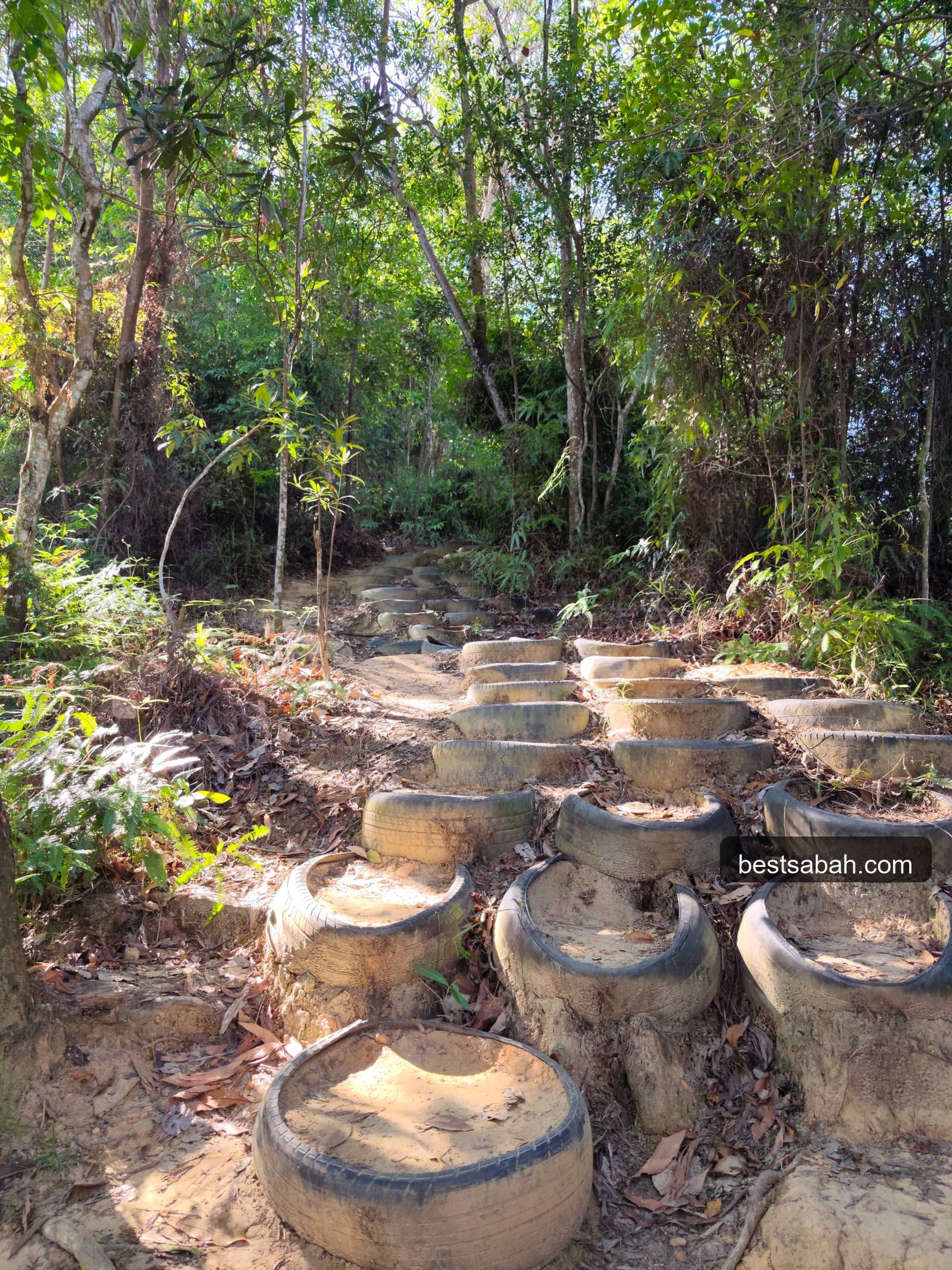 Old tyres used as steps on the Bukit Padang hiking trail Kota Kinabalu