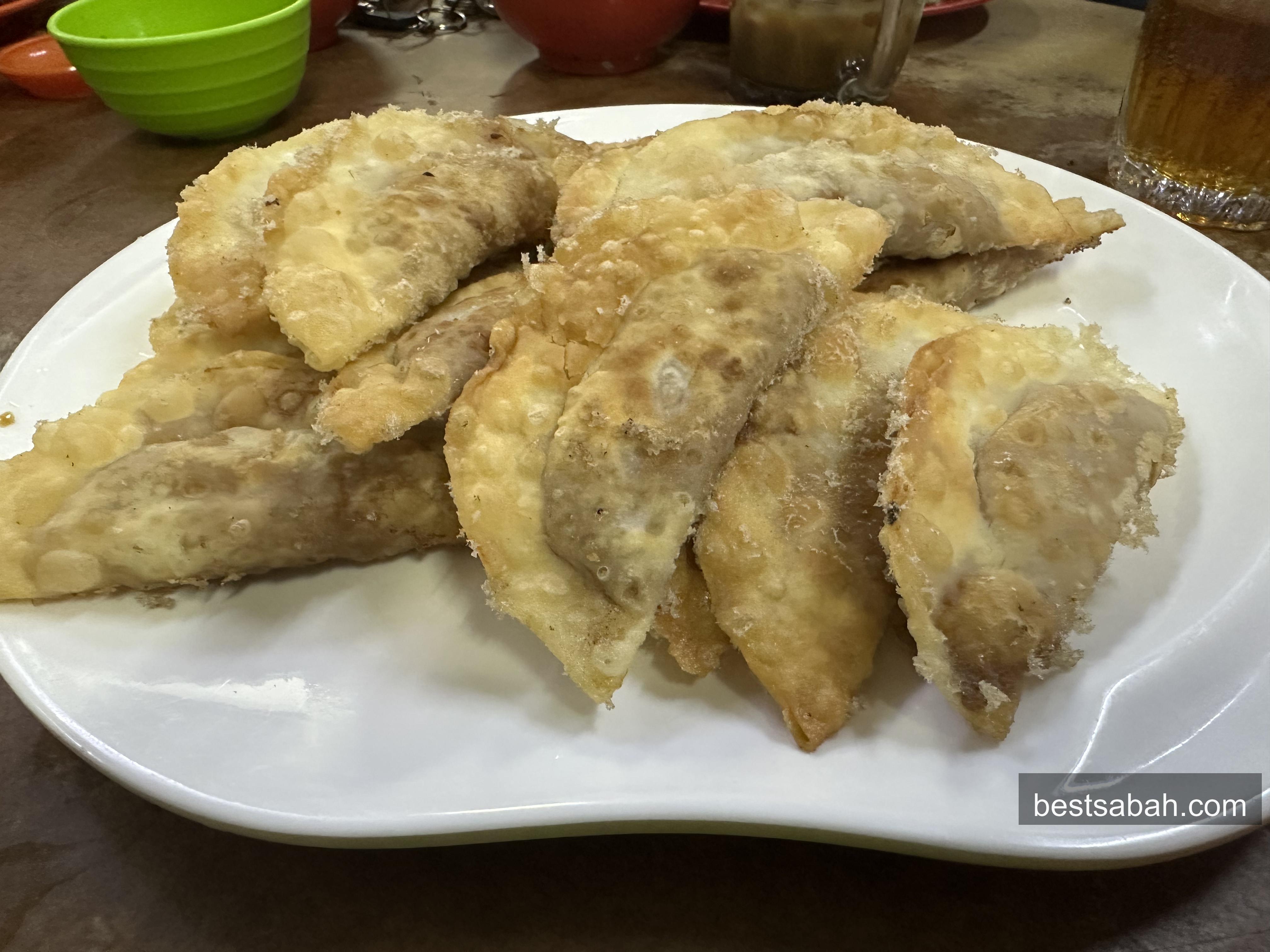 Plate of golden fried guo tie potstickers with crispy lace skirt at Ching Jie, Kai Shun