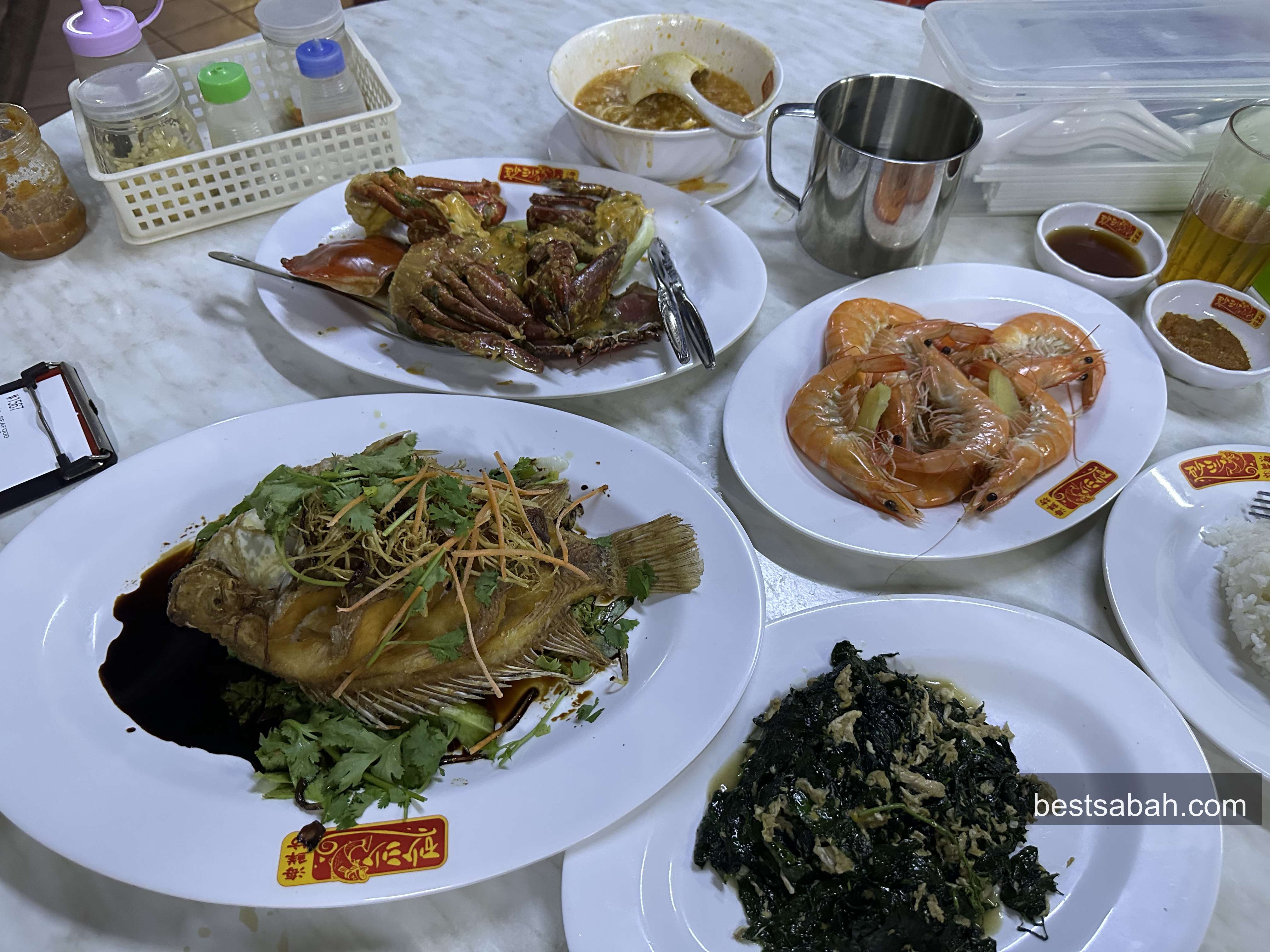 Full seafood spread at Sasa Seafood: steamed prawns, fried tilapia, Sabah vegetable, salted egg crab and soup