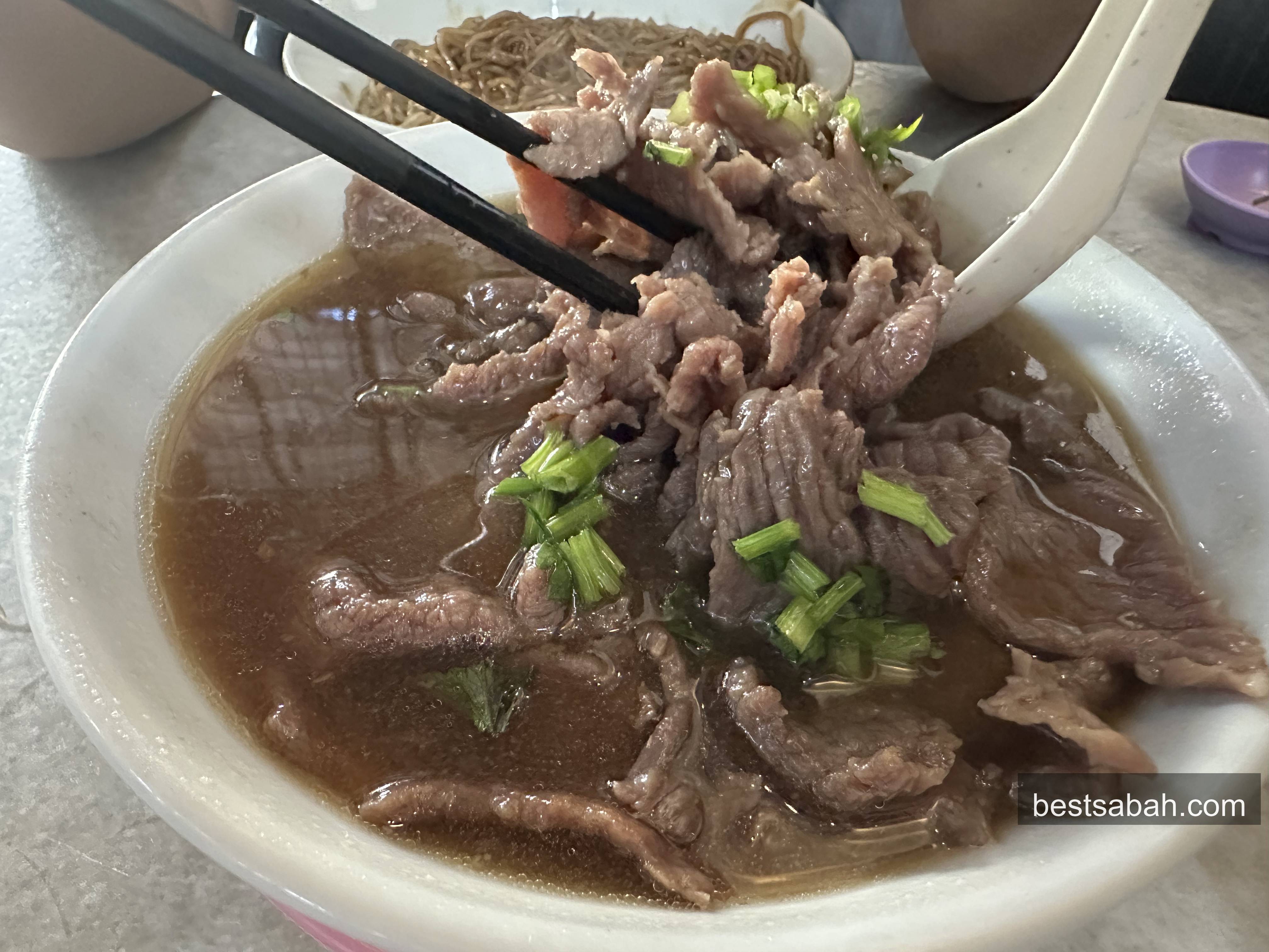 Bowl of clear beef soup at Yii Siang with tender beef cuts