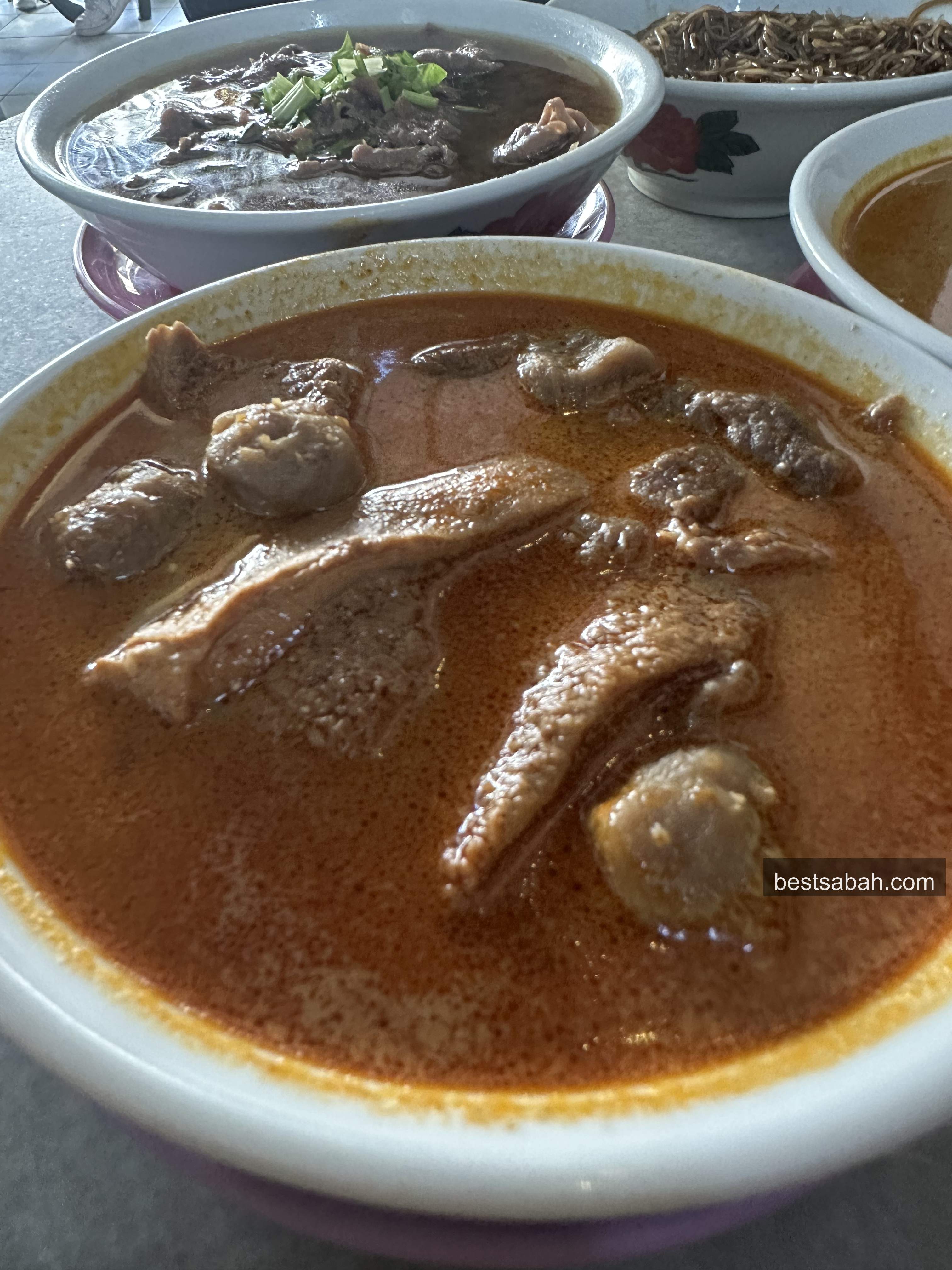 Close-up of Yii Siang ngiu chap laksa with rich spiced broth